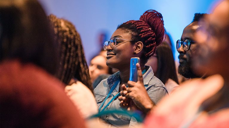 Focused shot of woman in a crowd attending a conference